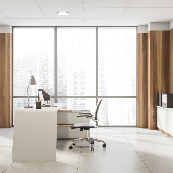 Chair and desk in office in front of a big window with sunshine