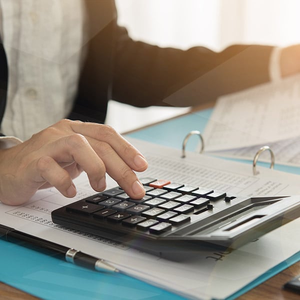 A close up of someone using a calculator